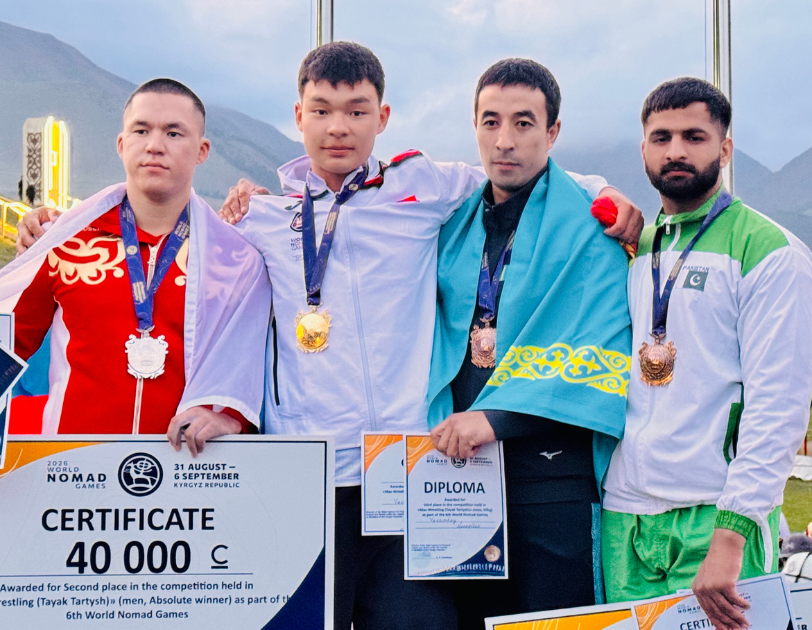 Muhammad Asim on the podium with his bronze medal certificate