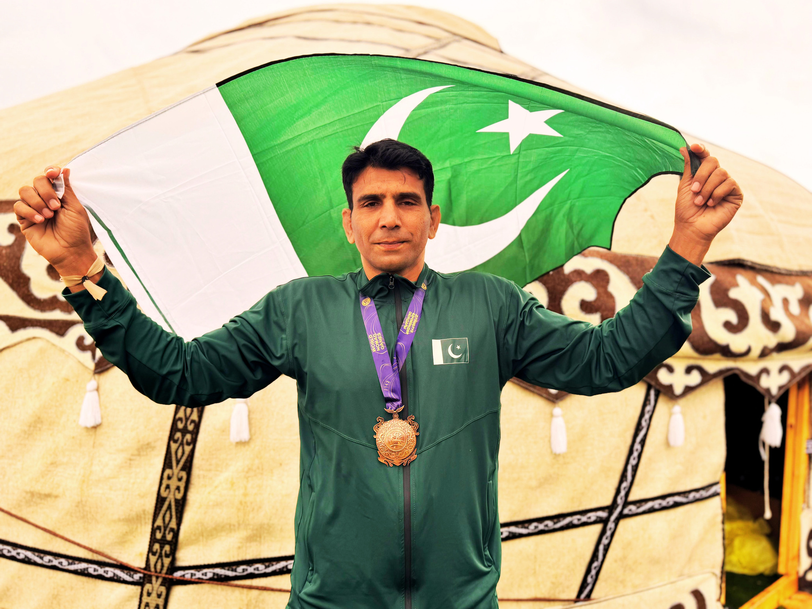 Captain Yasir Abbas Awan celebrating with the Pakistan flag